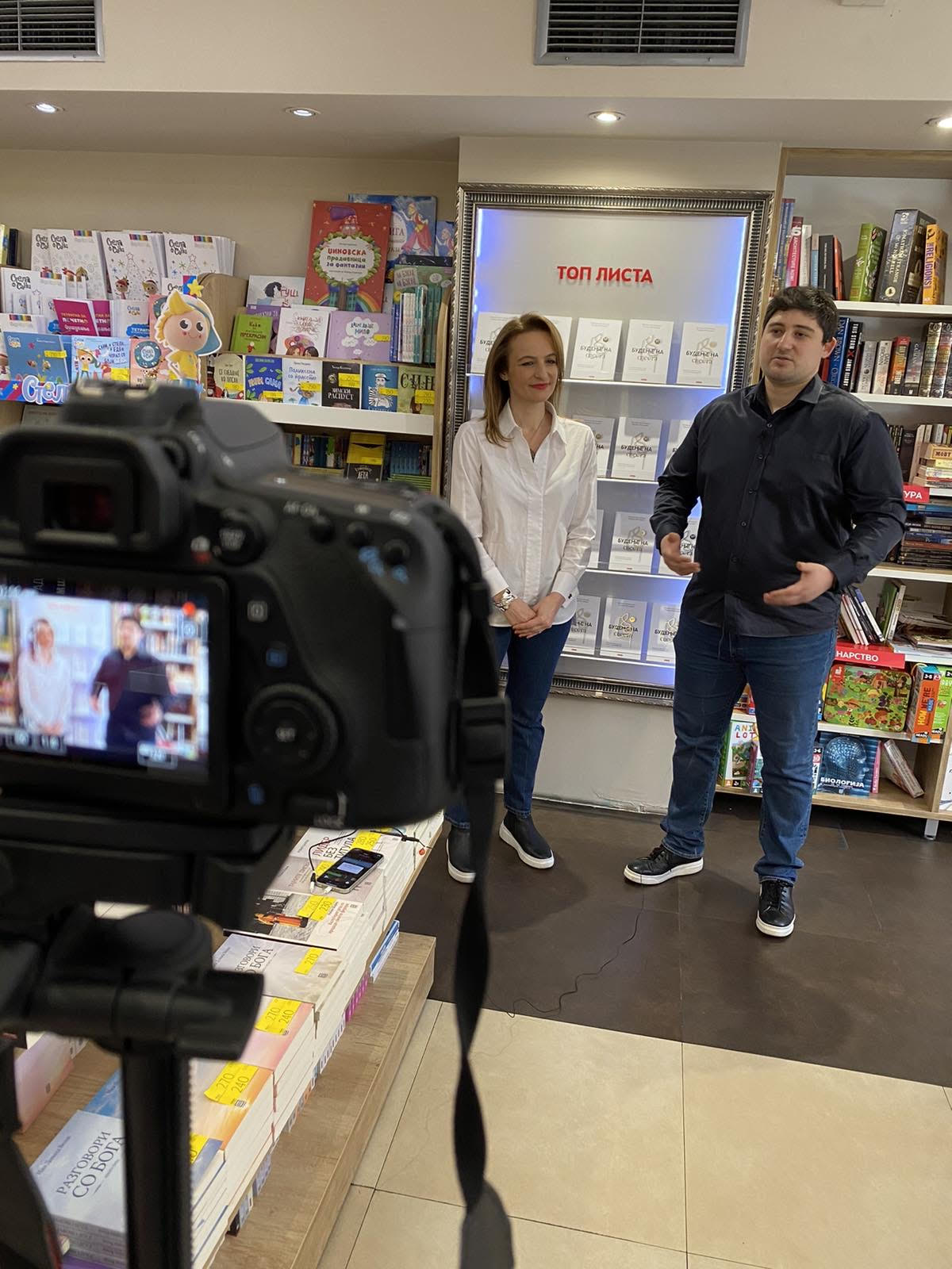 The authors being filmed at the Knizarnica Tri Top List display where Awakening Consciousness was featured